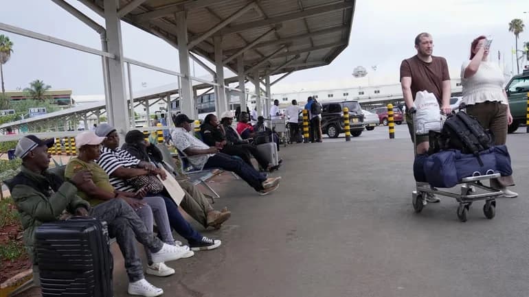 Passengers wait for their delayed flights at Jomo Kenyatta International Airport (JKIA) in Nairobi, Kenya, Monday, Feb. 16, 2026. Credit: AP/Brian Inganga